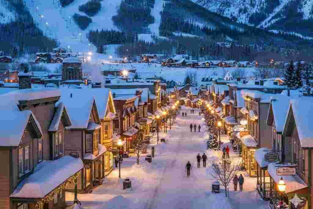 Breckenridge village at dusk with snow-covered roofs and warm lights